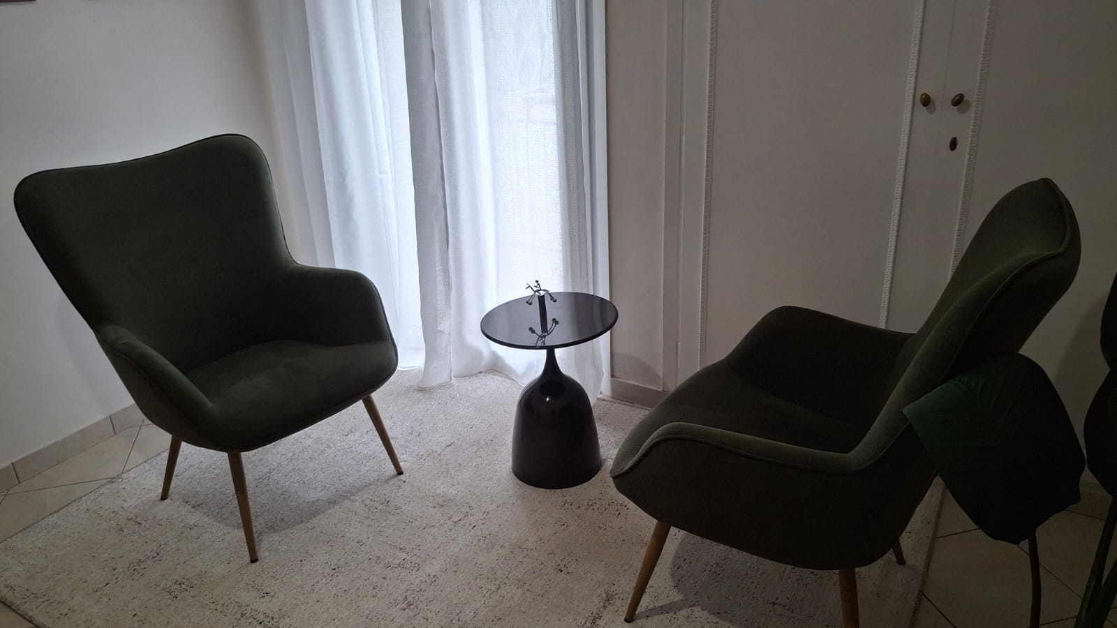 The practice room in Athens — two green armchairs by a window